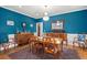 Formal dining room with wood table and ornate chandelier and wooden sideboard at 8605 Refuge Point Cir, North Charleston, SC 29420