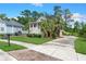 Charming home with a welcoming porch, lush landscaping, and convenient multi-car garage at 8605 Refuge Point Cir, North Charleston, SC 29420