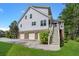 Stunning exterior view with multi-car garage, stairway to elevated deck, and beautiful landscaping at 8605 Refuge Point Cir, North Charleston, SC 29420