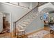 Elegant foyer with a grand staircase, hardwood floors, and stylish decor, creating a welcoming entrance at 8605 Refuge Point Cir, North Charleston, SC 29420