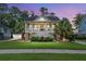Stunning two-story home featuring a grand front porch, well-manicured lawn, and lush landscaping at 8605 Refuge Point Cir, North Charleston, SC 29420