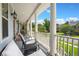 Relaxing front porch with comfortable seating, providing views of the lush surroundings and neighborhood at 8605 Refuge Point Cir, North Charleston, SC 29420