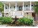 Inviting front porch with decorative railing, a water feature, and meticulously landscaped entryway at 8605 Refuge Point Cir, North Charleston, SC 29420