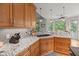 Kitchen boasts granite countertops, wood cabinets, stainless steel appliances, and a view to the breakfast nook at 8605 Refuge Point Cir, North Charleston, SC 29420