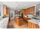 Spacious kitchen features wood cabinets, granite countertops, stainless steel appliances, and a central island at 8605 Refuge Point Cir, North Charleston, SC 29420