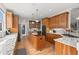 Modern kitchen with granite countertops, custom cabinetry, a center island, and stainless steel appliances at 8605 Refuge Point Cir, North Charleston, SC 29420