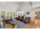 Open living room with hardwood floors, recliner seating, and view to kitchen area at 8605 Refuge Point Cir, North Charleston, SC 29420