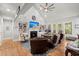 Bright living room with fireplace, built-in shelves, hardwood floors, and comfortable seating at 8605 Refuge Point Cir, North Charleston, SC 29420