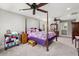Spacious main bedroom featuring a four-poster bed, ensuite bathroom, and neutral color palette at 8605 Refuge Point Cir, North Charleston, SC 29420