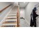 Stairway with wooden railings, treads and white risers leading to an upper level at 8605 Refuge Point Cir, North Charleston, SC 29420