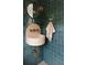 Stylish powder room featuring unique tilework, wall-mounted sink, and a round mirror at 926 Pitt St, Mount Pleasant, SC 29464