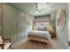 Stylish green bedroom featuring floral wallpaper, a ceiling fan, and a bed with decorative pillows at 926 Pitt St, Mount Pleasant, SC 29464