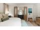 Comfortable bedroom with bed, bench, and natural light offers ensuite bathroom access at 926 Pitt St, Mount Pleasant, SC 29464