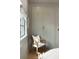 A bedroom closet is showcased in a well-lit setting, next to a chair near a window at 926 Pitt St, Mount Pleasant, SC 29464