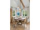 Cozy dining area with a round table, banquette seating, and elegant pendant lights at 926 Pitt St, Mount Pleasant, SC 29464