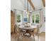 Charming dining area with round wooden table, bench seating and pendant lighting at 926 Pitt St, Mount Pleasant, SC 29464