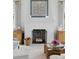 Close up of elegant fireplace with herringbone brick, adjacent wood cabinets and floral arrangement at 926 Pitt St, Mount Pleasant, SC 29464
