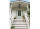 Front porch features a light blue door and steps adorned with potted plants at 926 Pitt St, Mount Pleasant, SC 29464