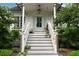 Welcoming front porch with white railing and stairs, complemented by colorful plants at 926 Pitt St, Mount Pleasant, SC 29464