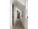 Hallway with a long runner, white walls, artwork, and lots of natural light at 926 Pitt St, Mount Pleasant, SC 29464