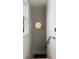 Hallway with wood railing, hanging designer light, and a window bringing in natural light at 926 Pitt St, Mount Pleasant, SC 29464