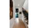 Hallway with stairs, a colorful painting, and doorway to a blue tiled bath at 926 Pitt St, Mount Pleasant, SC 29464