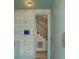 Stylish hallway with green walls, floral wallpaper, tall cabinets, and access to the staircase at 926 Pitt St, Mount Pleasant, SC 29464