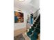 Hallway with stairs and a vibrant tapestry; a glimpse into the laundry room with modern appliances at 926 Pitt St, Mount Pleasant, SC 29464