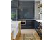 Well-organized kitchen with dark cabinets, long gold pulls and professional grade appliances at 926 Pitt St, Mount Pleasant, SC 29464