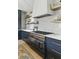 Beautiful kitchen with an island gas range, white countertops, and open shelving at 926 Pitt St, Mount Pleasant, SC 29464