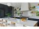 Stylish kitchen island with marble countertops, professional range, and triangular patterned backsplash at 926 Pitt St, Mount Pleasant, SC 29464