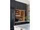 Modern kitchen with dark cabinets, wine glass display and built-in coffee maker at 926 Pitt St, Mount Pleasant, SC 29464
