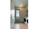 Bright laundry room with mint green cabinets, designer wallpaper, and modern washer and dryer at 926 Pitt St, Mount Pleasant, SC 29464