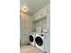 Modern laundry room with custom cabinets, floral wallpaper and new front load washer and dryer at 926 Pitt St, Mount Pleasant, SC 29464
