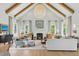 Bright living room with vaulted ceiling, wooden beams, fireplace and light blue accent chairs at 926 Pitt St, Mount Pleasant, SC 29464