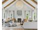Bright living room with high ceilings, exposed beams, and a cozy fireplace at 926 Pitt St, Mount Pleasant, SC 29464
