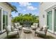 Comfortable outdoor seating area with four cushioned chairs and a modern white table at 926 Pitt St, Mount Pleasant, SC 29464