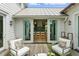 Charming patio with comfortable seating and a view of the modern kitchen at 926 Pitt St, Mount Pleasant, SC 29464