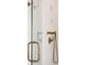 A detailed view of the shower featuring beautiful brass shower fixtures, white tile, and a clear glass door at 926 Pitt St, Mount Pleasant, SC 29464