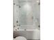 Bright bathroom with a bathtub and frameless glass shower featuring white square tiles at 926 Pitt St, Mount Pleasant, SC 29464