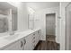 Bathroom featuring dual sink vanity, wood look flooring, and door to walk-in closet at 9712 Transplanter Cir, Ladson, SC 29456