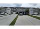 View of townhomes with individual garages and driveways, with tasteful neutral exterior colors, and well-manicured landscaping at 9712 Transplanter Cir, Ladson, SC 29456