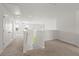 Bright hallway featuring neutral walls and carpet, with staircase and multiple doors at 9712 Transplanter Cir, Ladson, SC 29456