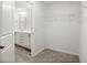 Walk-in closet leading to the bathroom that includes wire shelving and carpeted floor at 9712 Transplanter Cir, Ladson, SC 29456