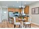 Well-lit kitchen with island seating, stainless steel appliances, and a dining area with decorative lighting at St, Saint George, SC 29477