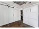 Bedroom with a sliding barn door, murphy bed and laundry area at 1 Cool Blow St # 124, Charleston, SC 29403