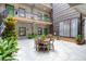 Open courtyard with tables, chairs, lush greenery, and multiple levels at 1 Cool Blow St # 124, Charleston, SC 29403