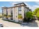 Modern condo building with concrete facade, large windows, and palm trees in Charleston, SC at 1 Cool Blow St # 124, Charleston, SC 29403