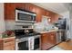 Bright kitchen with stainless appliances, stone counters, and wood floors at 1 Cool Blow St # 124, Charleston, SC 29403
