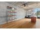 Bright, open floor plan featuring a concrete ceiling, hardwood floors, and modern shelving at 1 Cool Blow St # 124, Charleston, SC 29403
